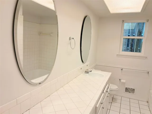 a bathroom with a sink a mirror and a shower