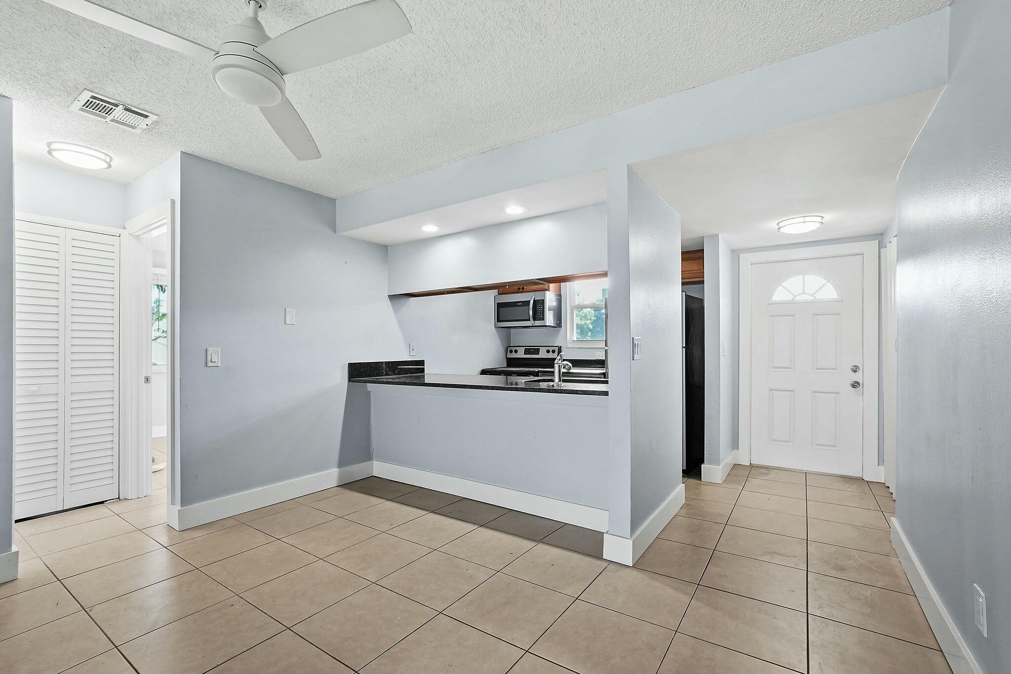 983 Northwest Spruce Ridge Drive, Unit 4 Stuart, FL 34994 - Photo 15 of 56 a view of hallway with kitchen