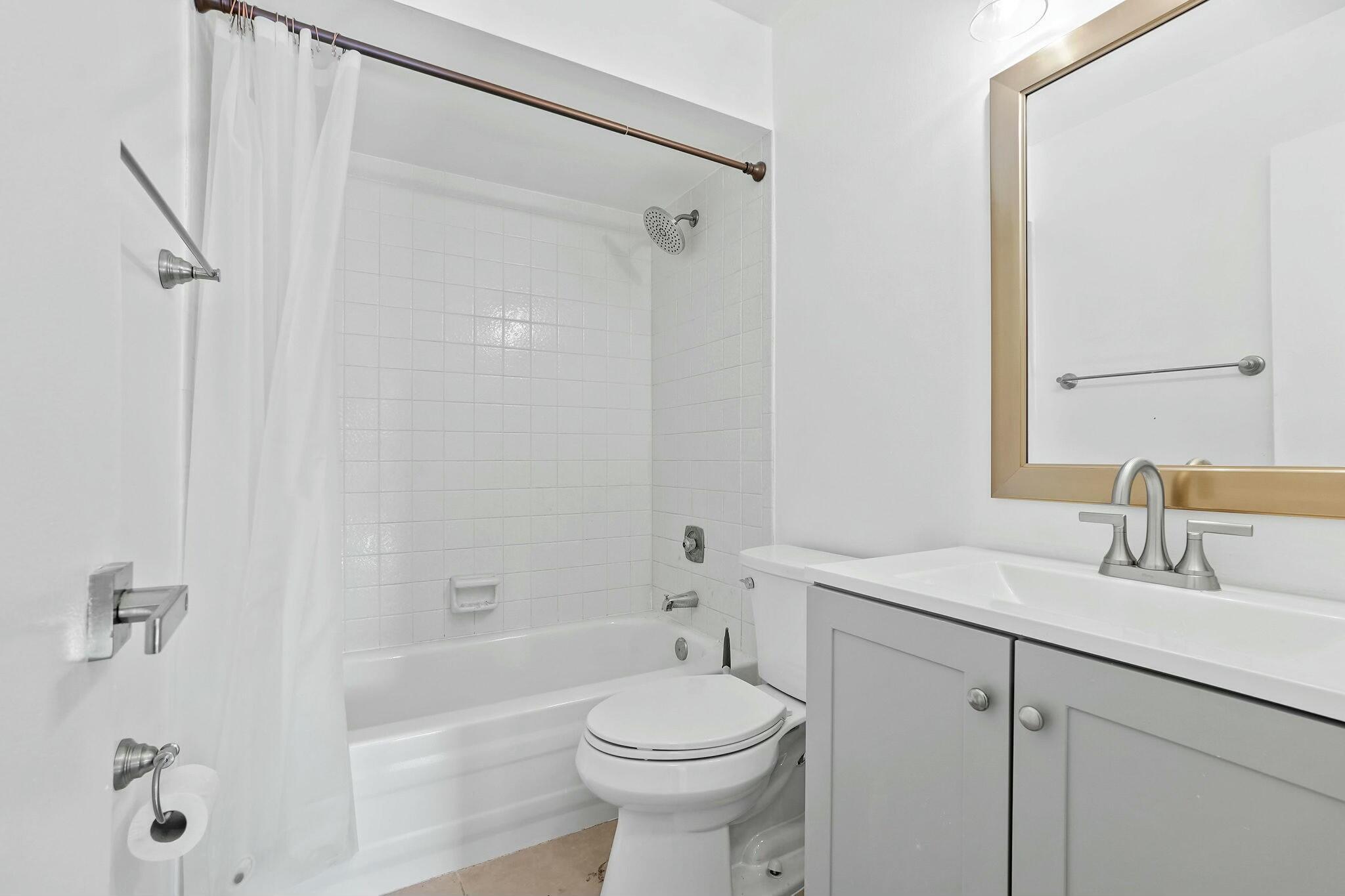 983 Northwest Spruce Ridge Drive, Unit 4 Stuart, FL 34994 - Photo 17 of 56 a bathroom with a sink a toilet and shower
