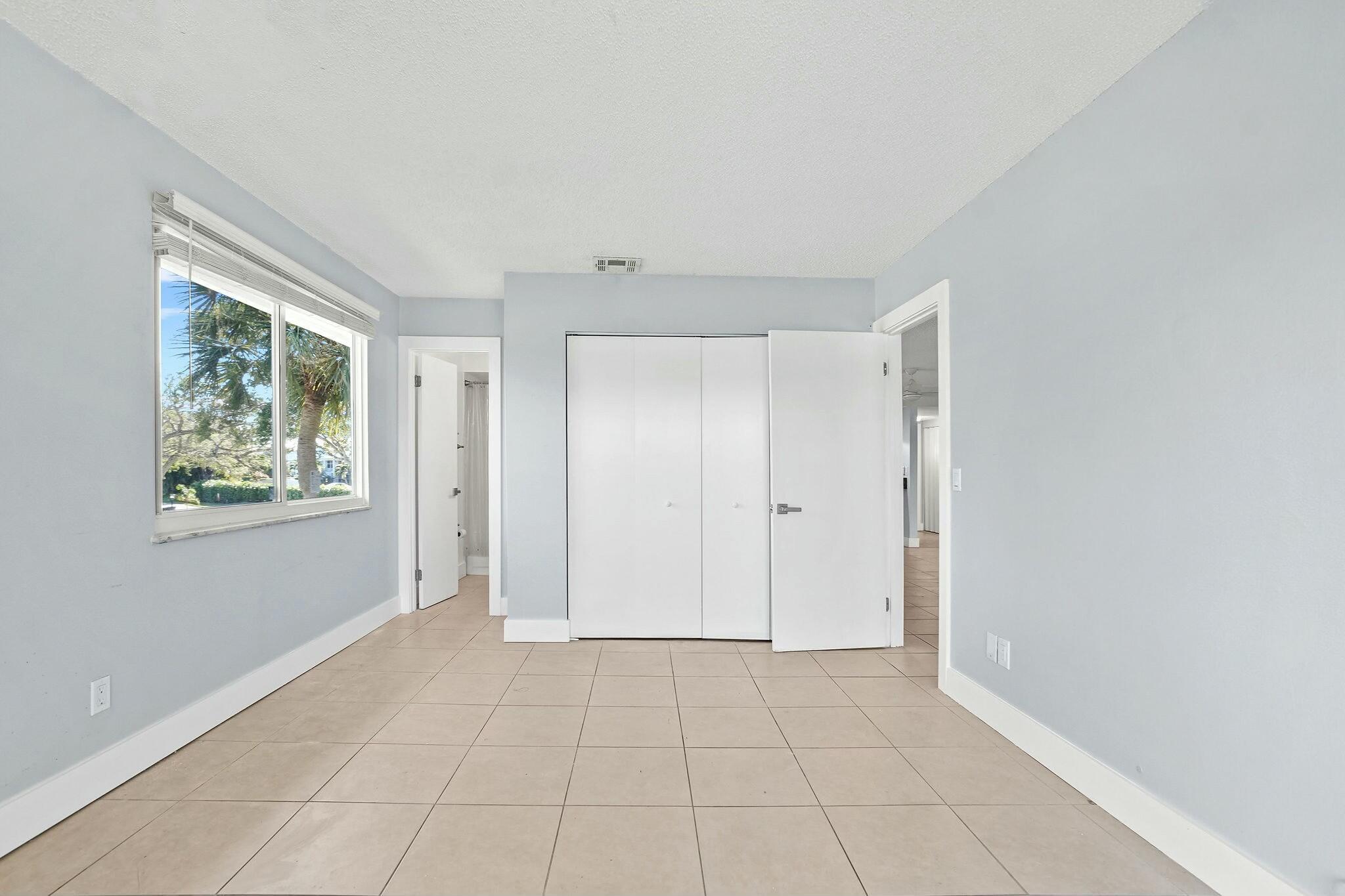 983 Northwest Spruce Ridge Drive, Unit 4 Stuart, FL 34994 - Photo 23 of 56 a view of an empty room with window and closet area