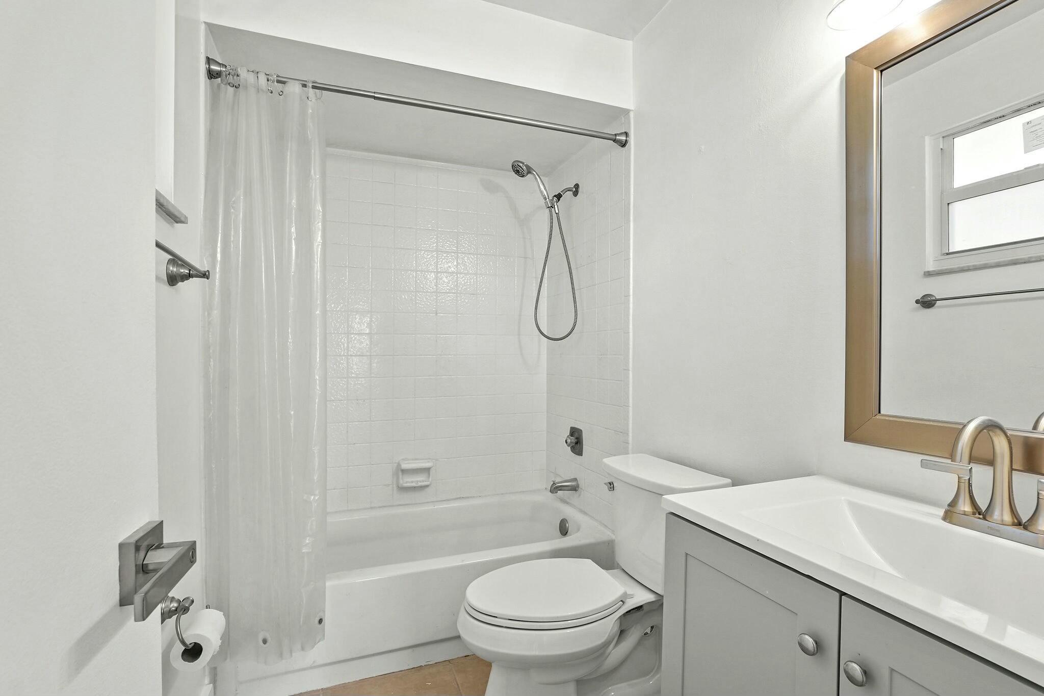 983 Northwest Spruce Ridge Drive, Unit 4 Stuart, FL 34994 - Photo 25 of 56 a bathroom with a sink toilet vanity and shower