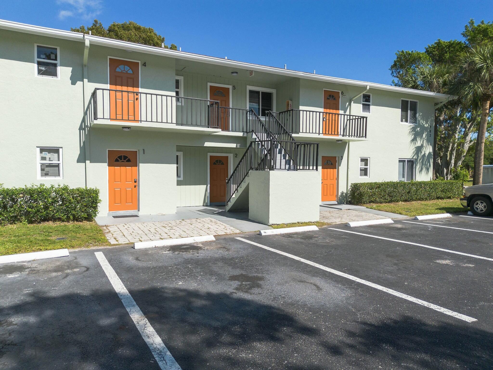 983 Northwest Spruce Ridge Drive, Unit 4 Stuart, FL 34994 - Photo 33 of 56 a front view of a house with a yard and garage
