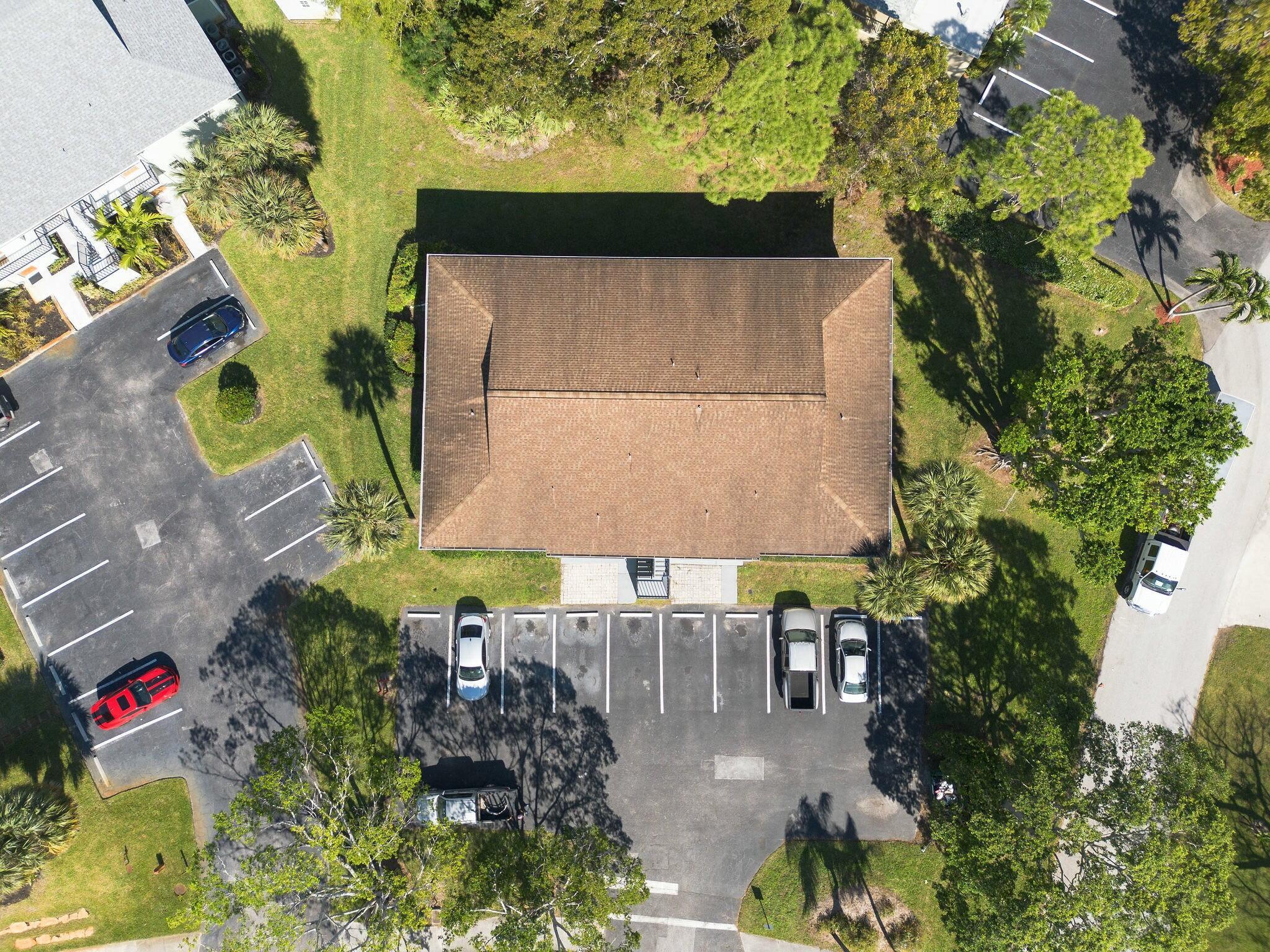 983 Northwest Spruce Ridge Drive, Unit 4 Stuart, FL 34994 - Photo 37 of 56 an outdoor space with seating area and trees