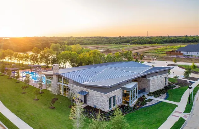 an aerial view of a house with big yard