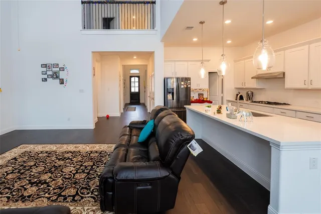 a room with wooden floor and lots of furniture