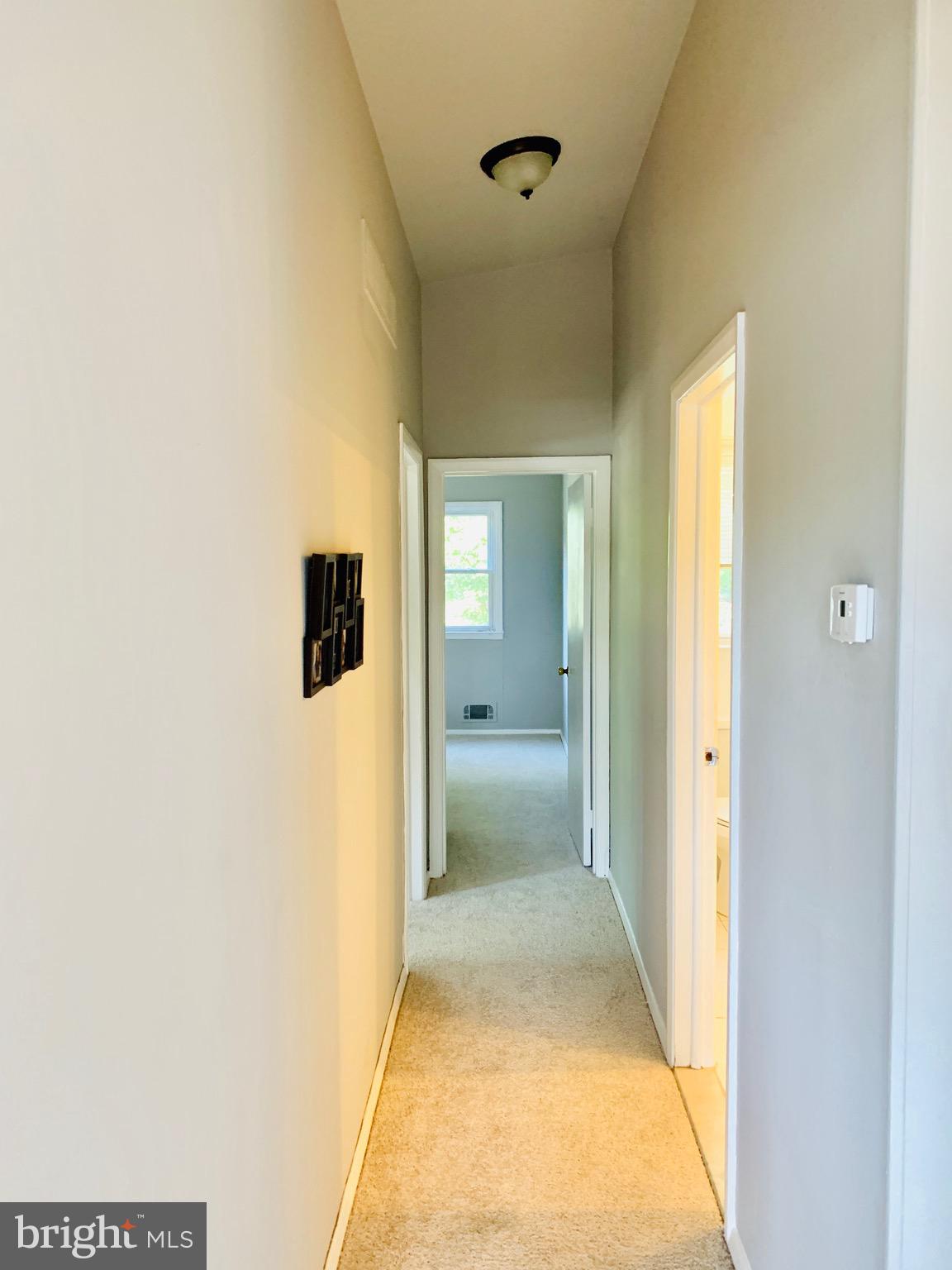 8508 Stevenswood Road Baltimore, MD 21244 - Photo 17 of 45 a view of a hallway with wooden floor and a bathroom