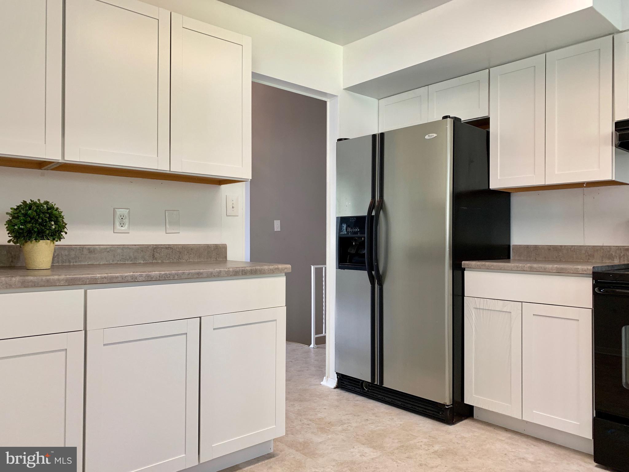 8508 Stevenswood Road Baltimore, MD 21244 - Photo 9 of 45 a kitchen with cabinets and stainless steel appliances