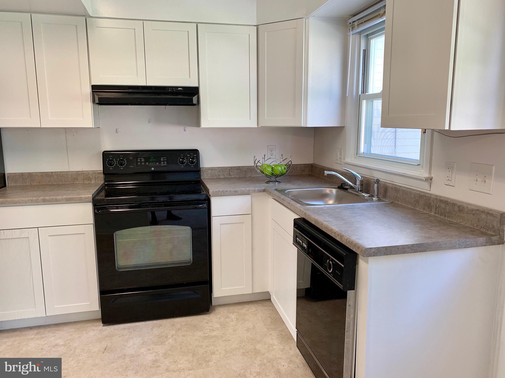 8508 Stevenswood Road Baltimore, MD 21244 - Photo 10 of 45 a kitchen with a sink stove and cabinets