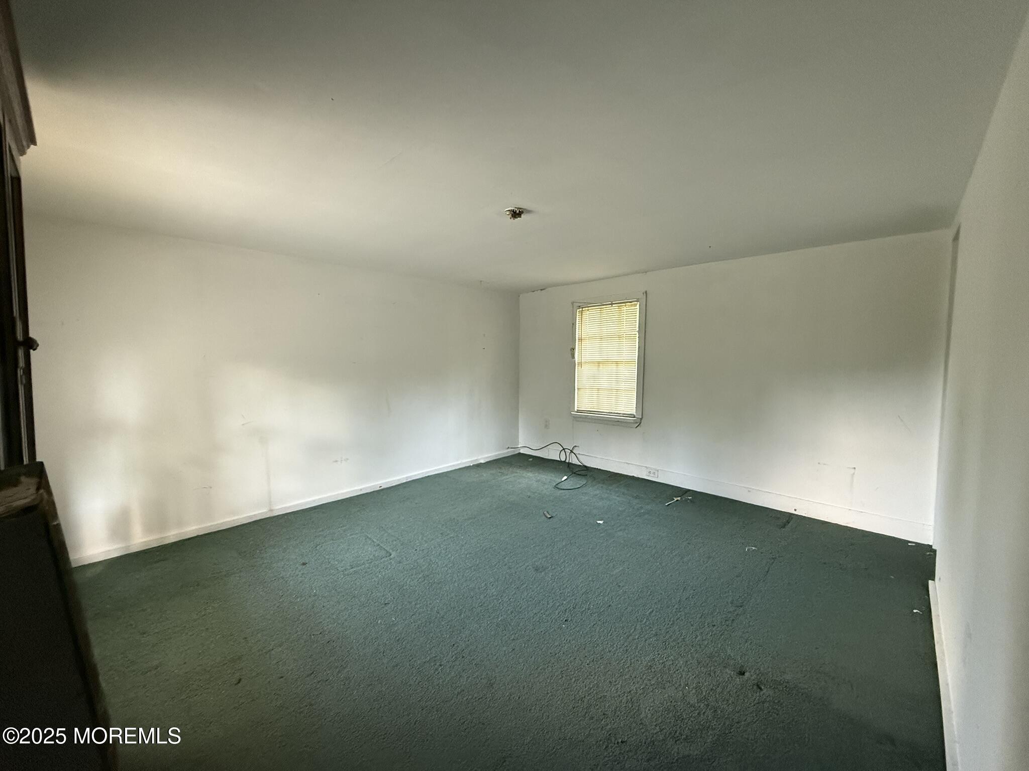 225 Jones Road, Unit 104 Barnegat, NJ 08005 - Photo 13 of 44 a view of an empty room with a window