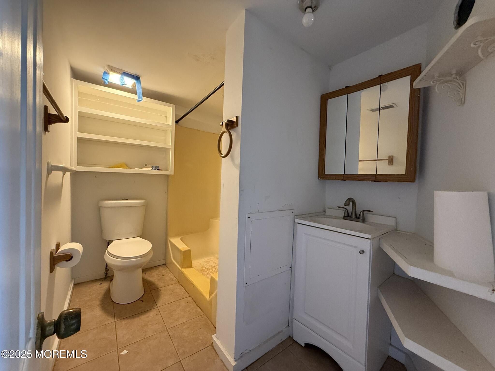 225 Jones Road, Unit 104 Barnegat, NJ 08005 - Photo 3 of 44 a bathroom with a toilet a sink and mirror