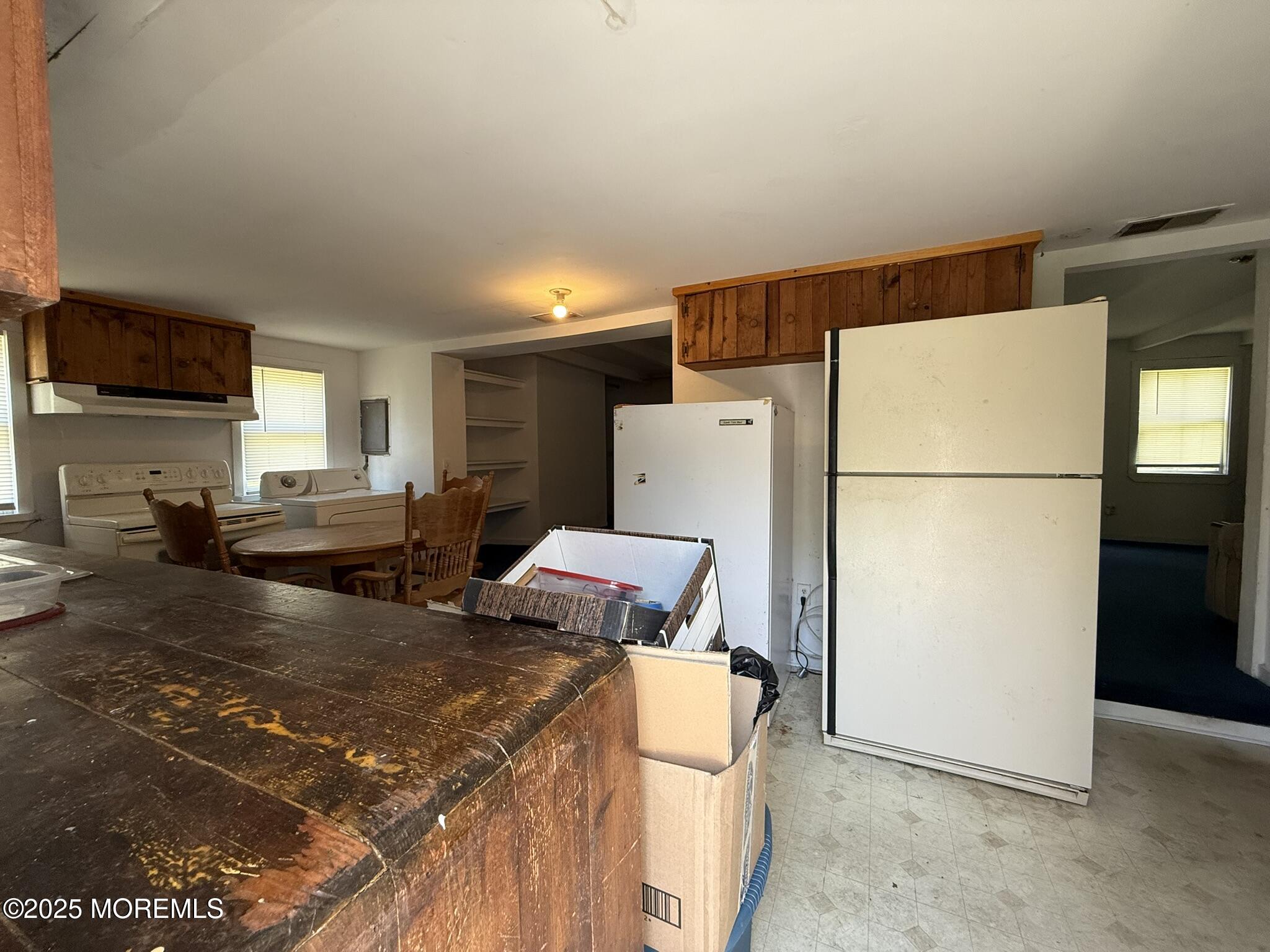 225 Jones Road, Unit 104 Barnegat, NJ 08005 - Photo 6 of 44 a kitchen that has a refrigerator and a stove in it