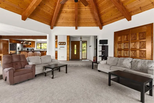 a kitchen with stainless steel appliances granite countertop a sink and a refrigerator