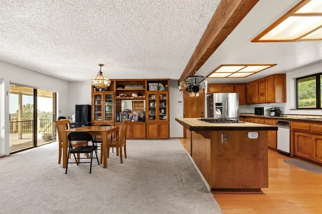 a kitchen with stainless steel appliances granite countertop a sink a stove and a refrigerator