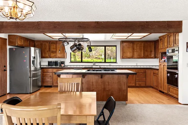 a kitchen with stainless steel appliances granite countertop a stove and a sink