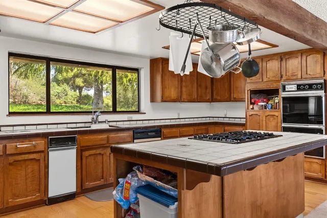 a kitchen with stainless steel appliances granite countertop a stove and a refrigerator