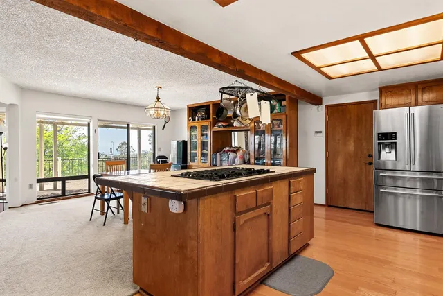 a bed sitting in a spacious bedroom next to a window