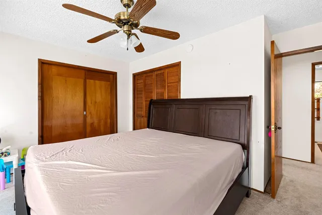 a bed sitting in a room next to a window