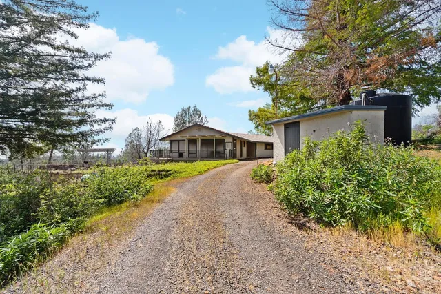 a front view of house with yard and green space