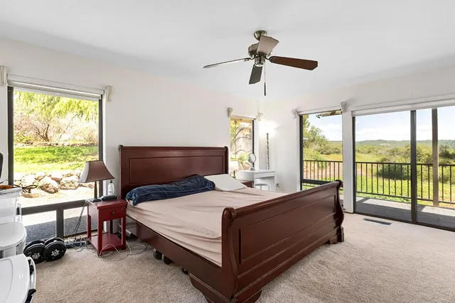 a bathroom with a granite countertop sink a mirror and a toilet