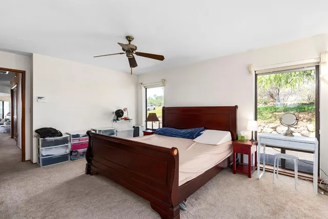 a bathroom with double vanity sinks a mirror and a shower
