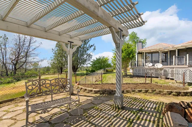 a view of yard with swimming pool and green space