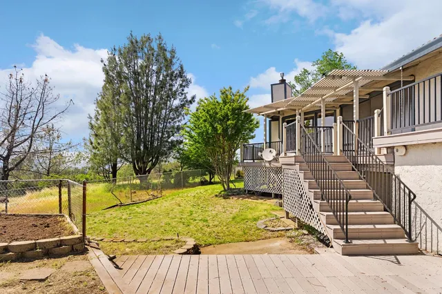 a white house with a yard and garden