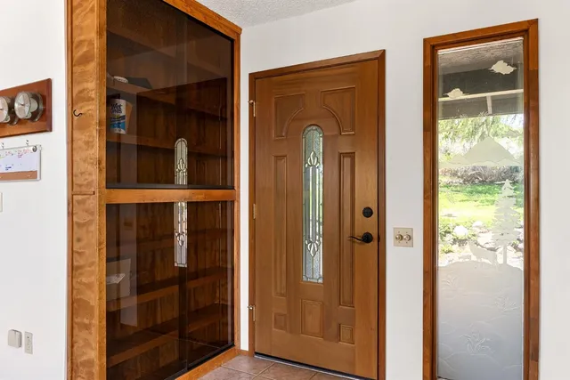 a living room with furniture a flat screen tv and a floor to ceiling window
