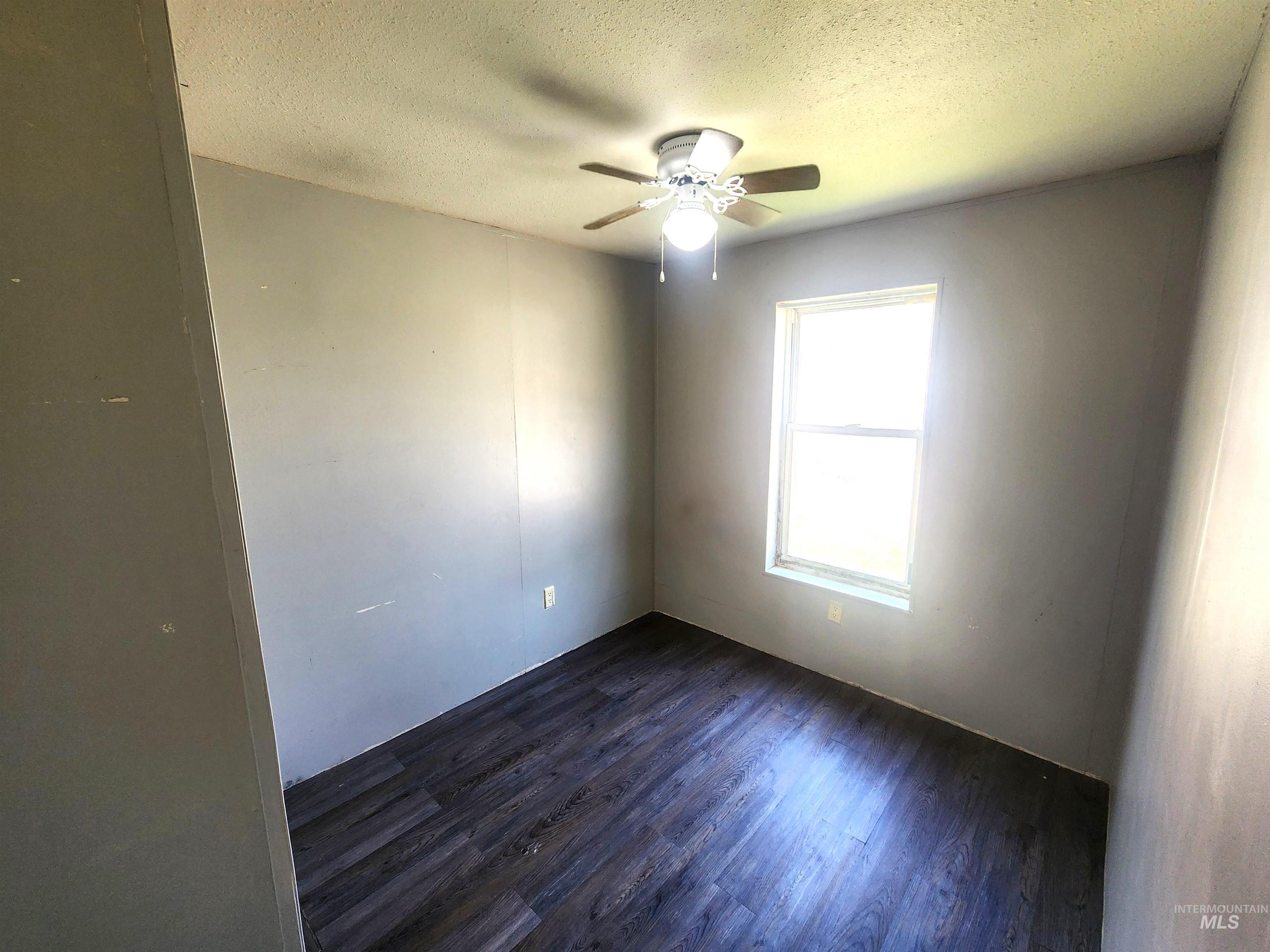 616 North Kings Road Nampa, ID 83687 - Photo 9 of 12 Room featuring wood-finish flooring, a ceiling fan with light fixture, and a single window