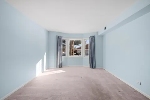 a view of a big room with windows and cabinet