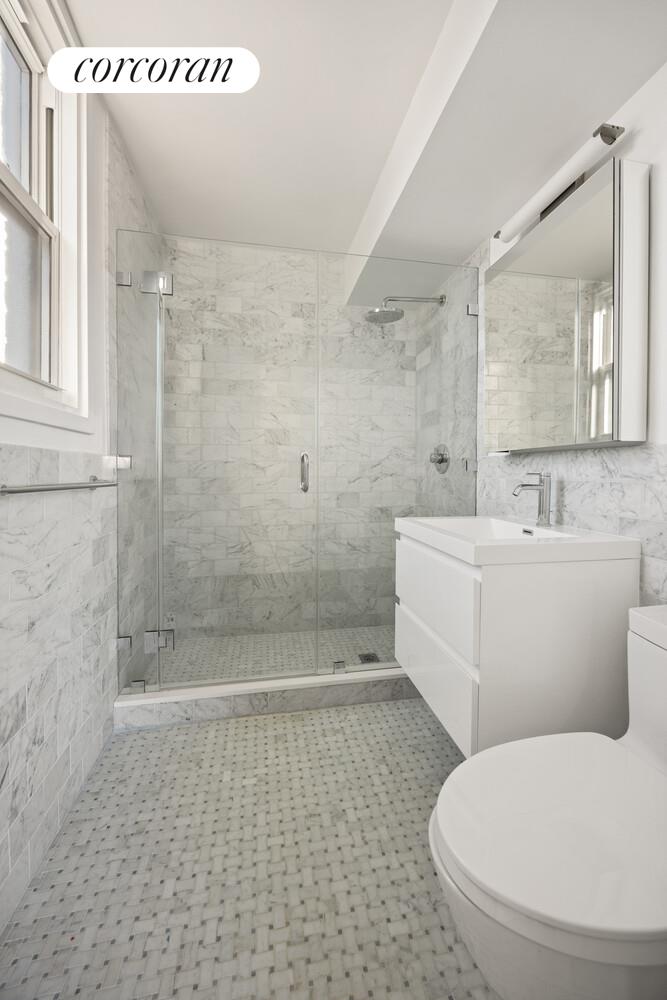61 Jane Street, Unit 14J Manhattan, NY 10014 - Photo 6 of 8 a bathroom with a toilet and a shower
