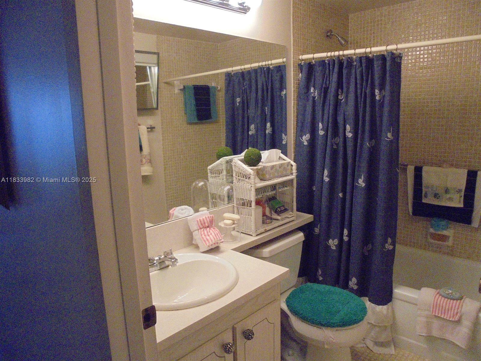 31 Fanshaw A, Unit 31A Boca Raton, FL 33434 - Photo 4 of 12 a bathroom with a sink toilet and shower