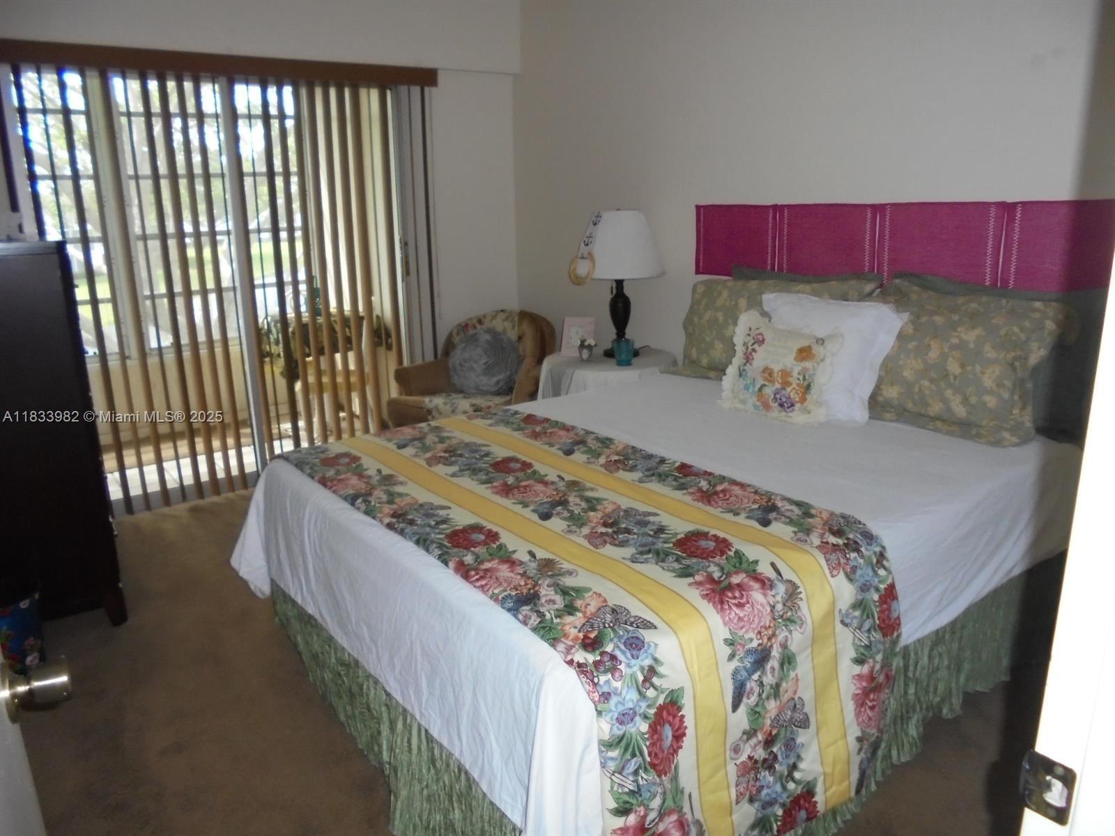 31 Fanshaw A, Unit 31A Boca Raton, FL 33434 - Photo 5 of 12 a bedroom with a bed and a window