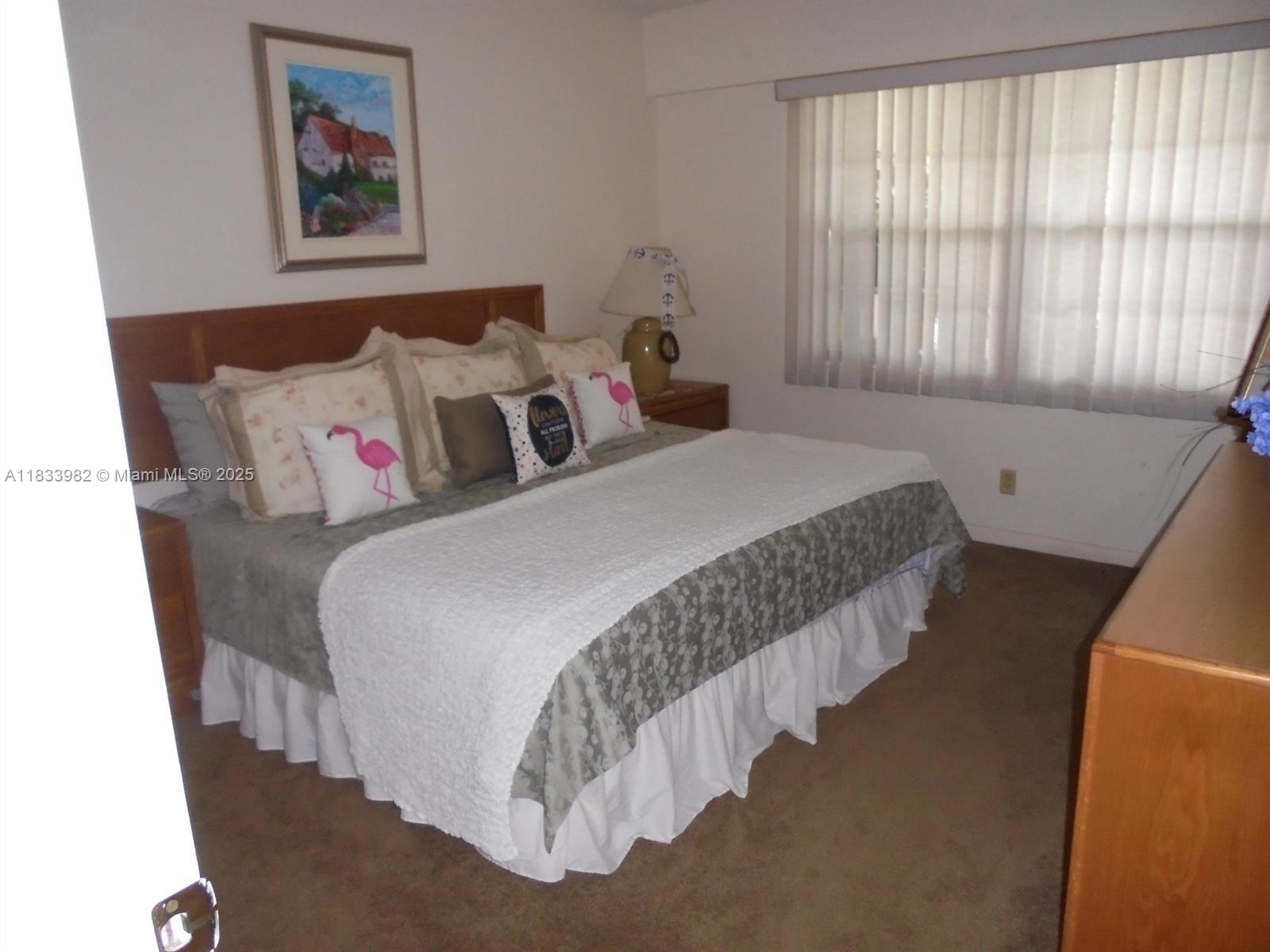 31 Fanshaw A, Unit 31A Boca Raton, FL 33434 - Photo 6 of 12 a bedroom with bed and a window