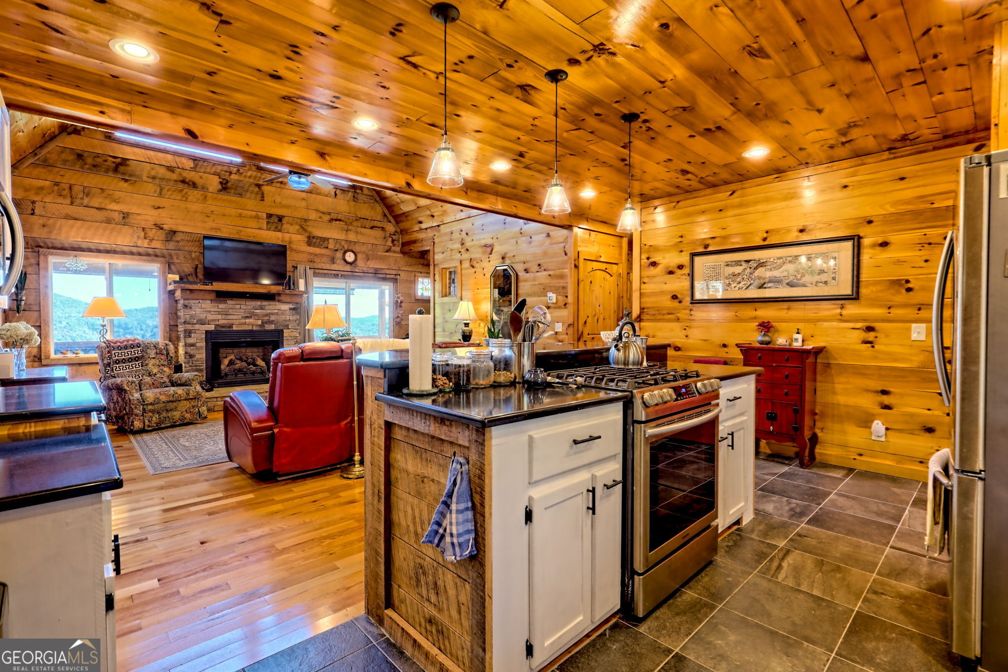 557 Walnut Grove Lane Tiger, GA 30576 - Photo 14 of 75 a kitchen with stainless steel appliances granite countertop a stove and a wooden cabinets