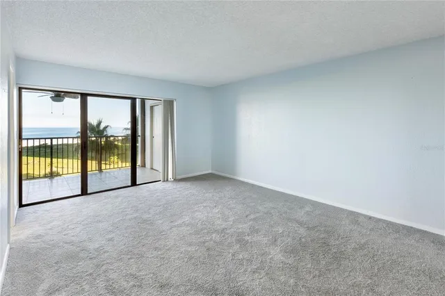 an empty room with large windows