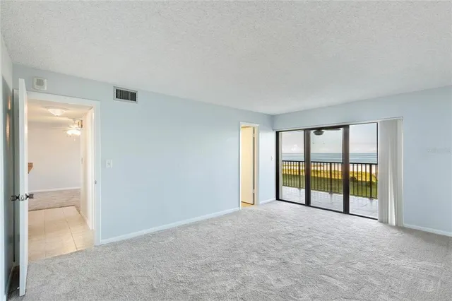 a view of an empty room and a bathroom