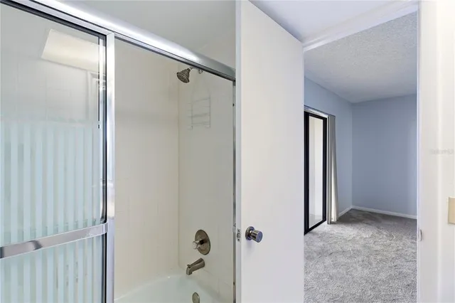 a bathroom with a glass shower door