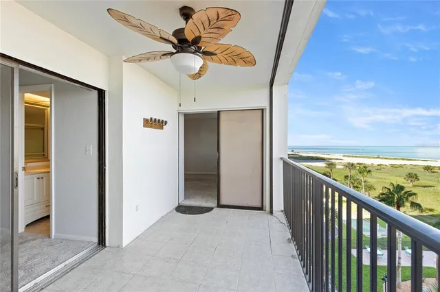 an aerial view of residential houses with outdoor space and ocean view