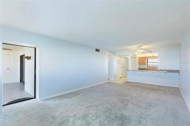 an empty room with fire place and mirror