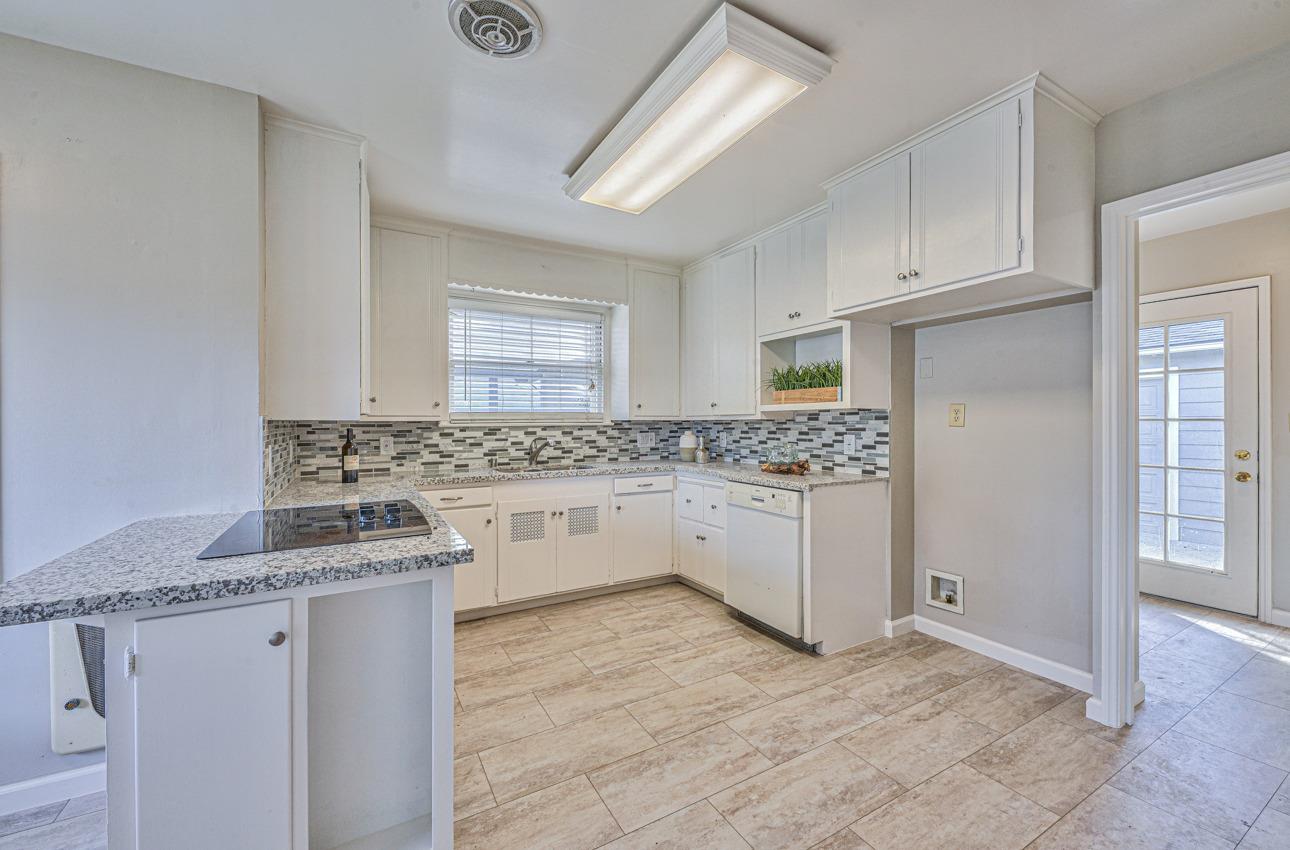 402 Lorimer Street Salinas, CA 93901 - Photo 12 of 36 a kitchen with granite countertop white cabinets and white appliances