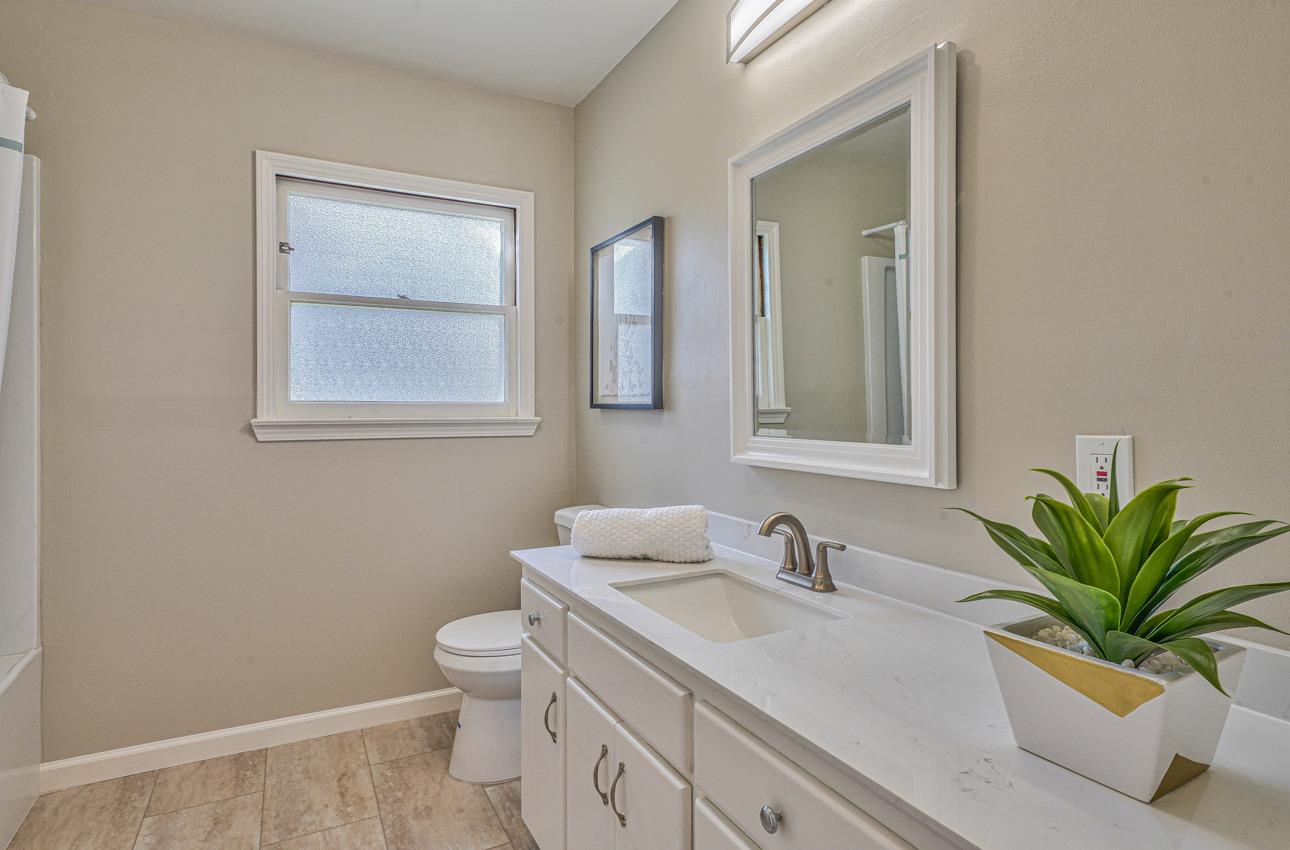 402 Lorimer Street Salinas, CA 93901 - Photo 25 of 36 a bathroom with a toilet a sink and mirror