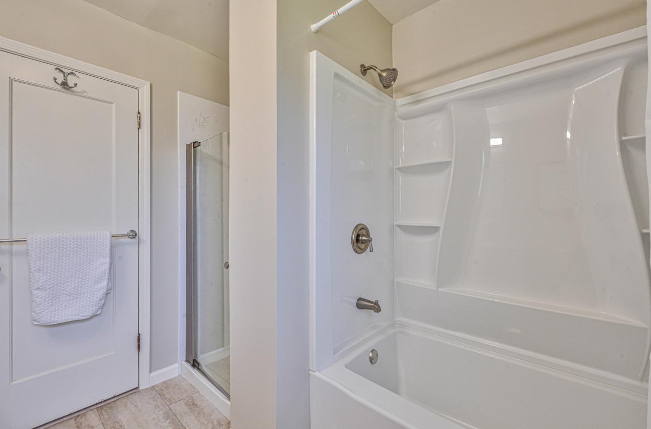 402 Lorimer Street Salinas, CA 93901 - Photo 26 of 36 a bathroom with a bathtub and a shower