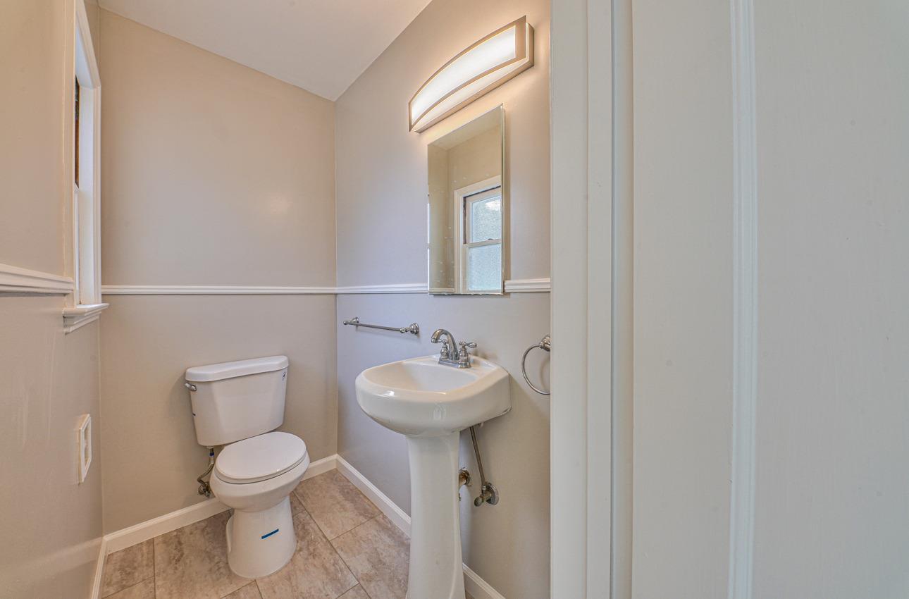 402 Lorimer Street Salinas, CA 93901 - Photo 30 of 36 a bathroom with a toilet sink and mirror