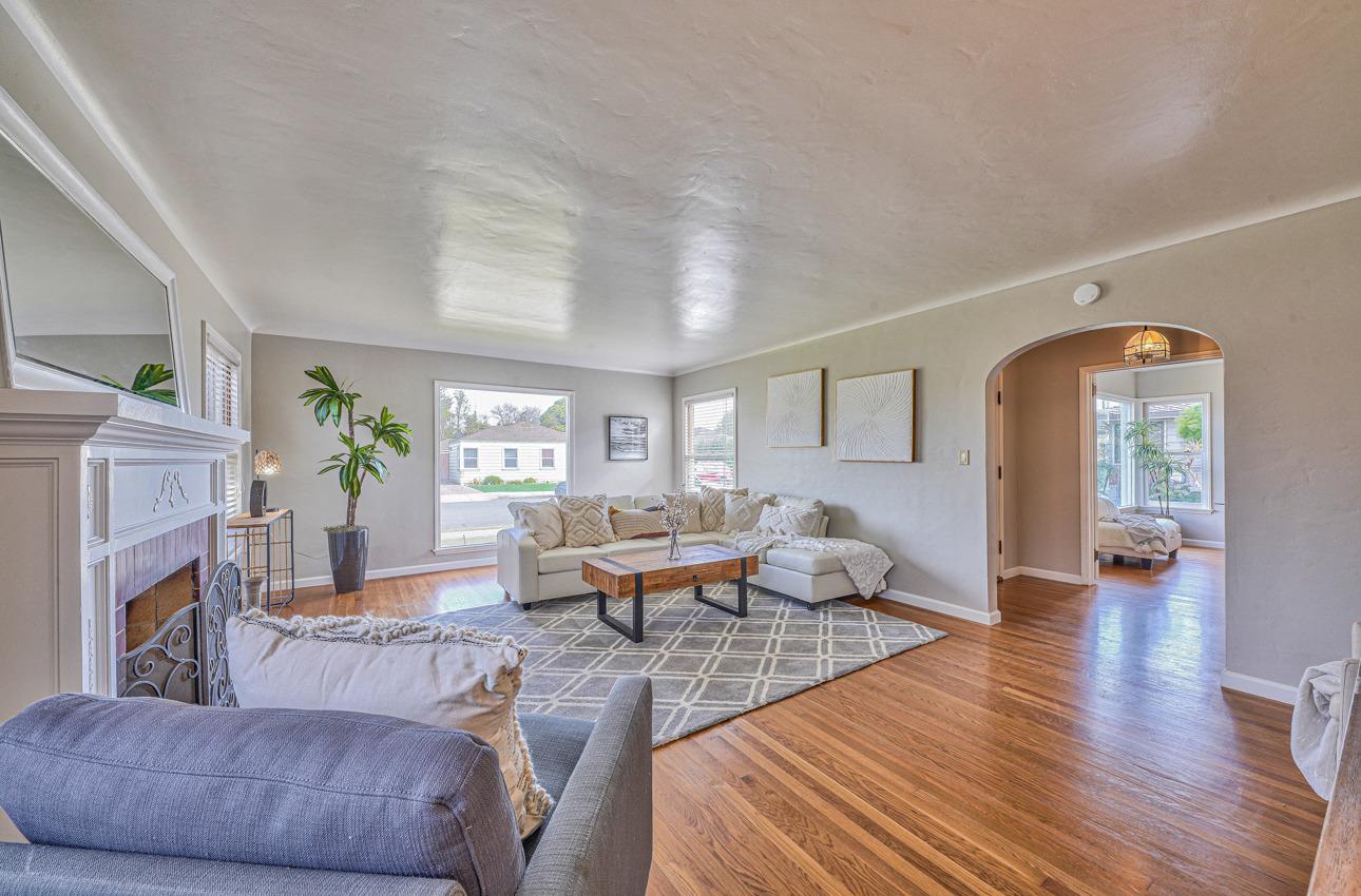 402 Lorimer Street Salinas, CA 93901 - Photo 6 of 36 a living room with fireplace furniture and a wooden floor