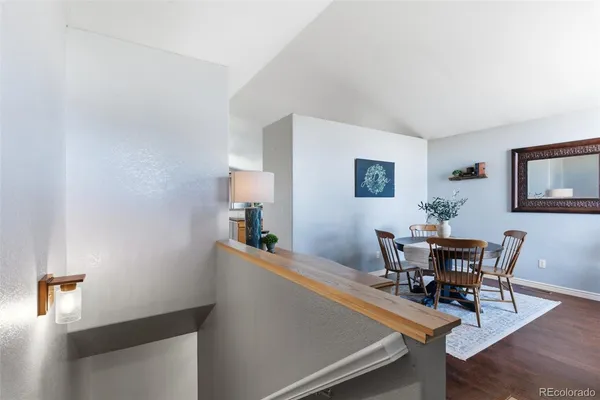 a dining room with furniture and wooden floor