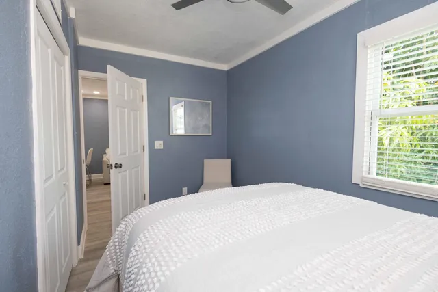 a bedroom with a bed and a window