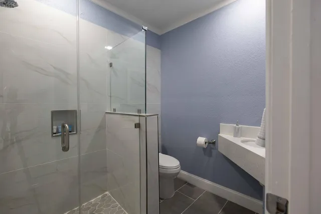 a bathroom with a toilet sink and shower