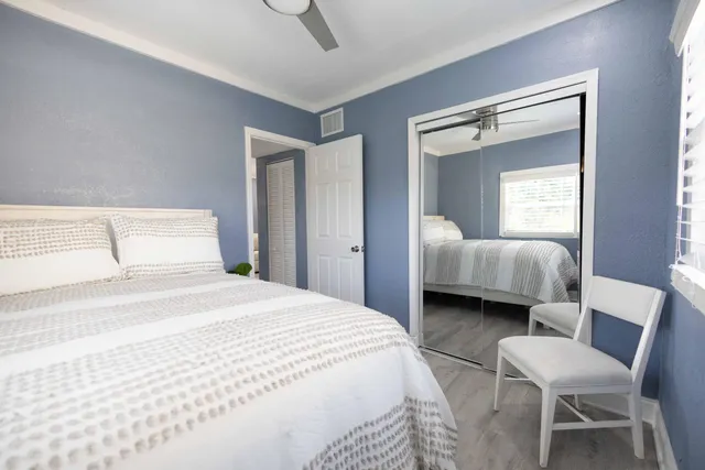 a bedroom with a bed and a chair