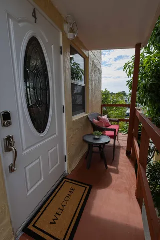 a living room with furniture and a floor to ceiling window
