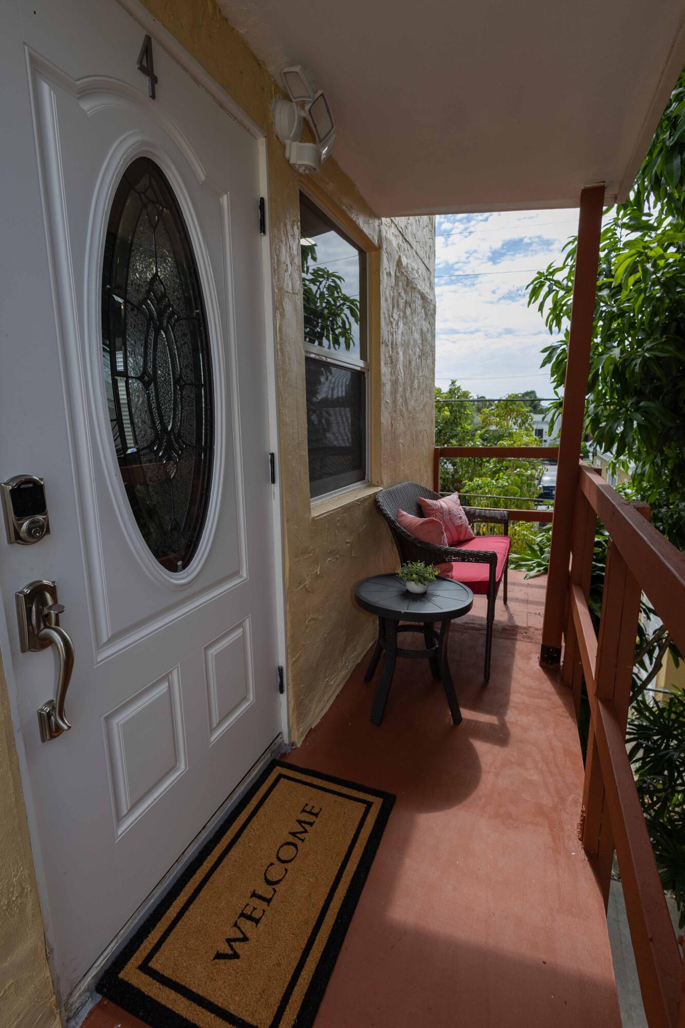 420 Avenida Alegre, Unit 4 West Palm Beach, FL 33405 - Photo 23 of 33 a living room with furniture and a floor to ceiling window